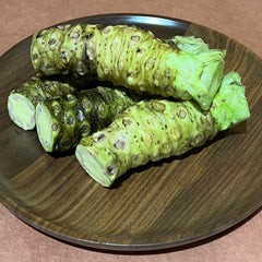 1 lb of fresh wasabi rhizomes on a wood plate